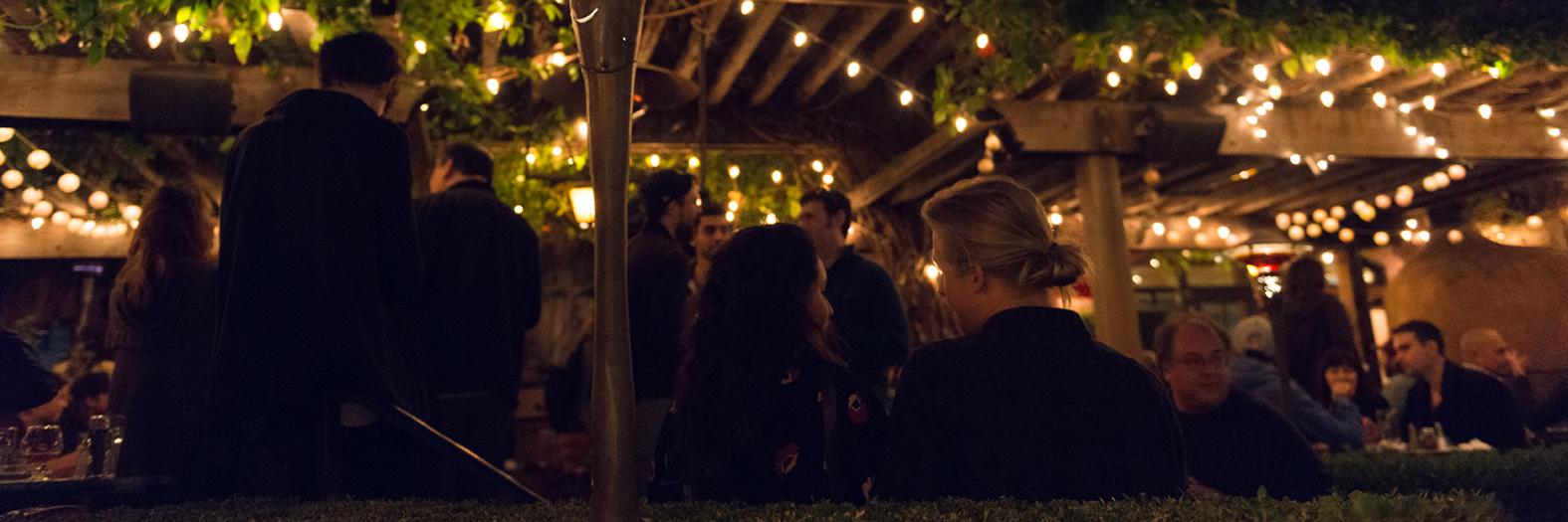 A twilight scene in the courtyard of Jupiter, with strands of lights twinkling overhead