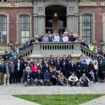 A large group of MICS students pose in front of South Hall at the spring 2024 on-campus immersion