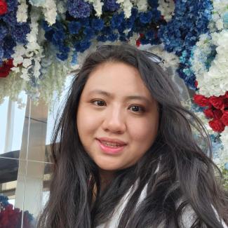 Profile Photo of Pauline Chane under arrangement of various flowers