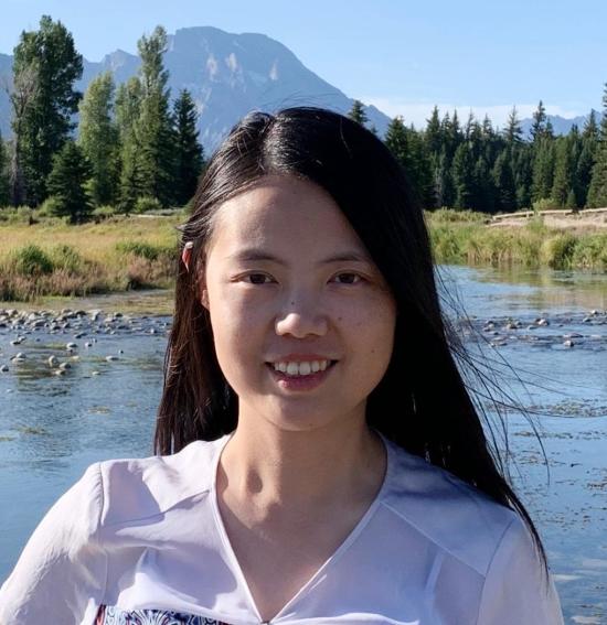 woman in white shirt, in the forest by a lake