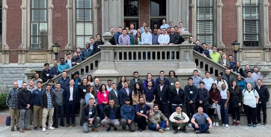 A large group of MICS students pose in front of South Hall at the spring 2024 on-campus immersion