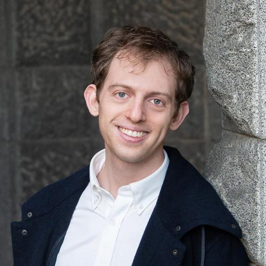 headshot of nick Merrill in white button up