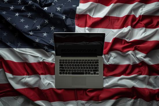 Close-up of laptop on American flag (AI-generated image)